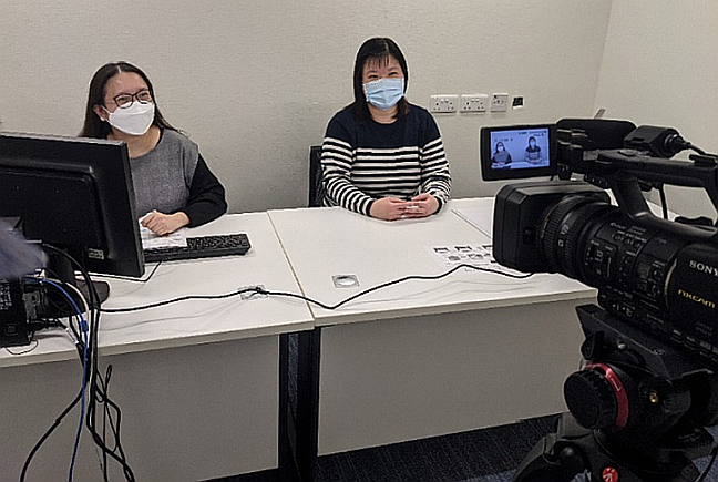  Ms Yeung (right) holding a briefing session